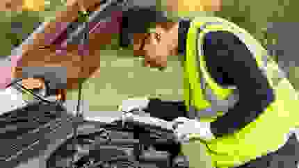 roadside assistance mechanic fixing an engine